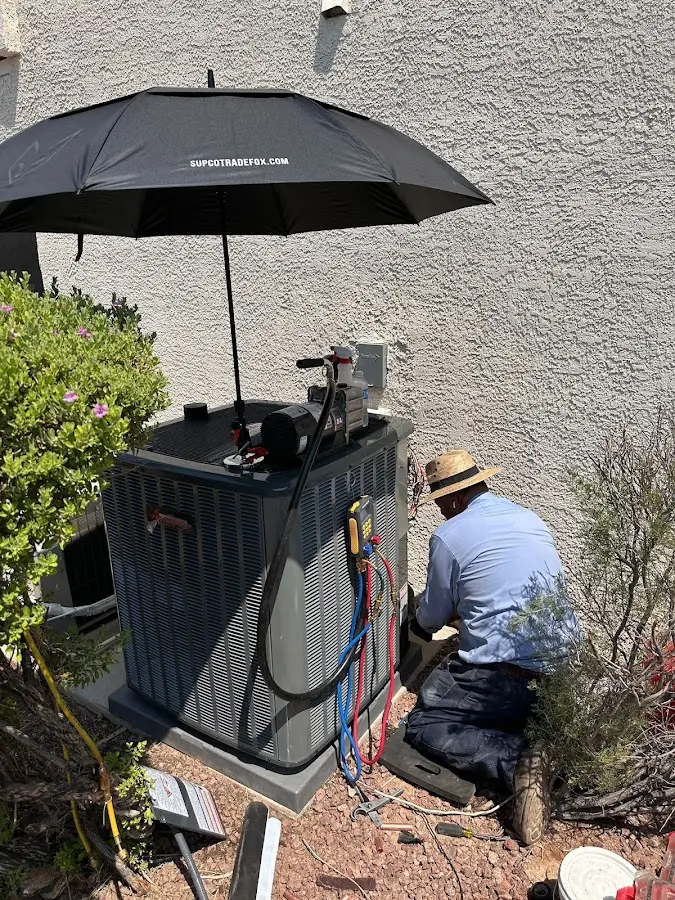 HVAC technician performing outdoor AC maintenance in Lakeland South